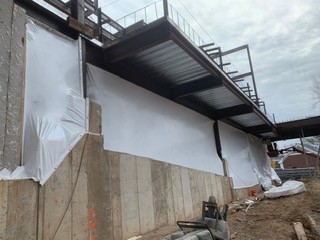 Building Shrink Wrapping in New York City – providing coverage for new concrete and heat for the construction workers.